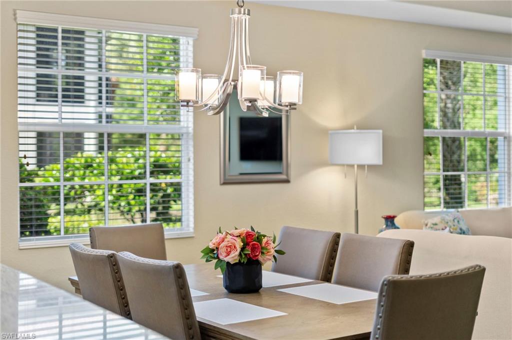 7837 Hawthorne Drive, Unit 1101 Naples, FL 34113 - Photo 26 of 41 a living room with furniture and a large window