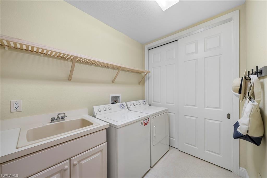 7837 Hawthorne Drive, Unit 1101 Naples, FL 34113 - Photo 29 of 41 a utility room with dryer and washer