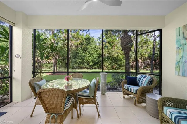 a dining room with furniture and a floor to ceiling window