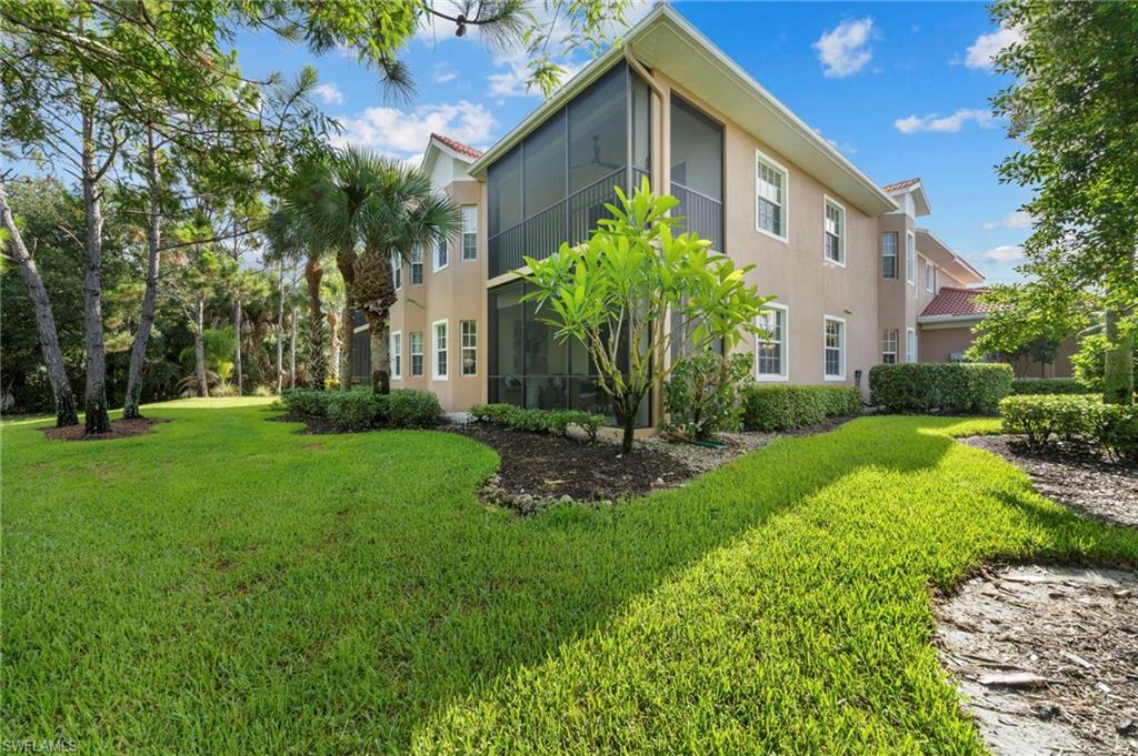 7837 Hawthorne Drive, Unit 1101 Naples, FL 34113 - Photo 33 of 41 a front view of a house with a garden
