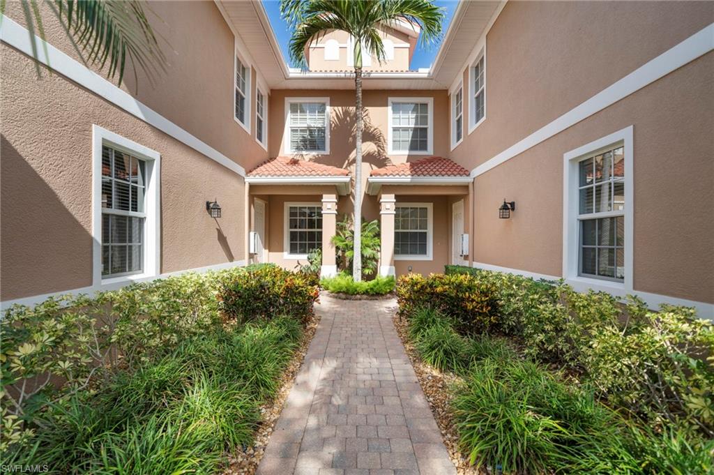 7837 Hawthorne Drive, Unit 1101 Naples, FL 34113 - Photo 35 of 41 front view of a house with a garden