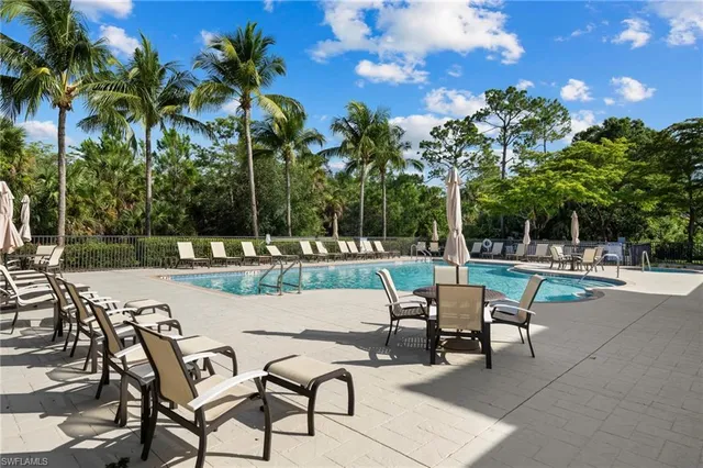 a view of a swimming pool with a patio and a garden
