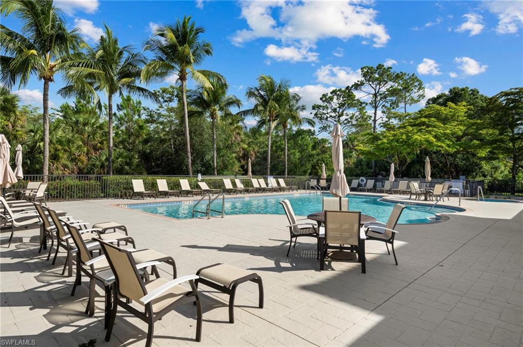 7837 Hawthorne Drive, Unit 1101 Naples, FL 34113 - Photo 36 of 41 a view of a patio with a table and chairs