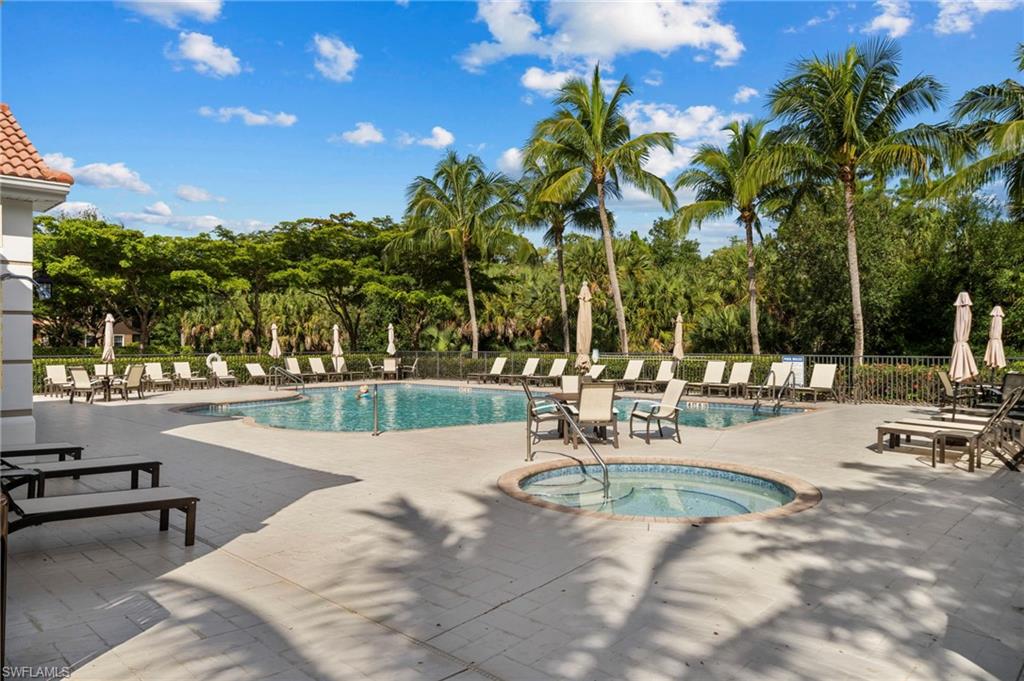 7837 Hawthorne Drive, Unit 1101 Naples, FL 34113 - Photo 37 of 41 a view of a swimming pool with a patio and a garden