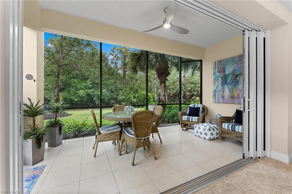 7837 Hawthorne Drive, Unit 1101 Naples, FL 34113 - Photo 5 of 41 a living room with patio furniture and garden view