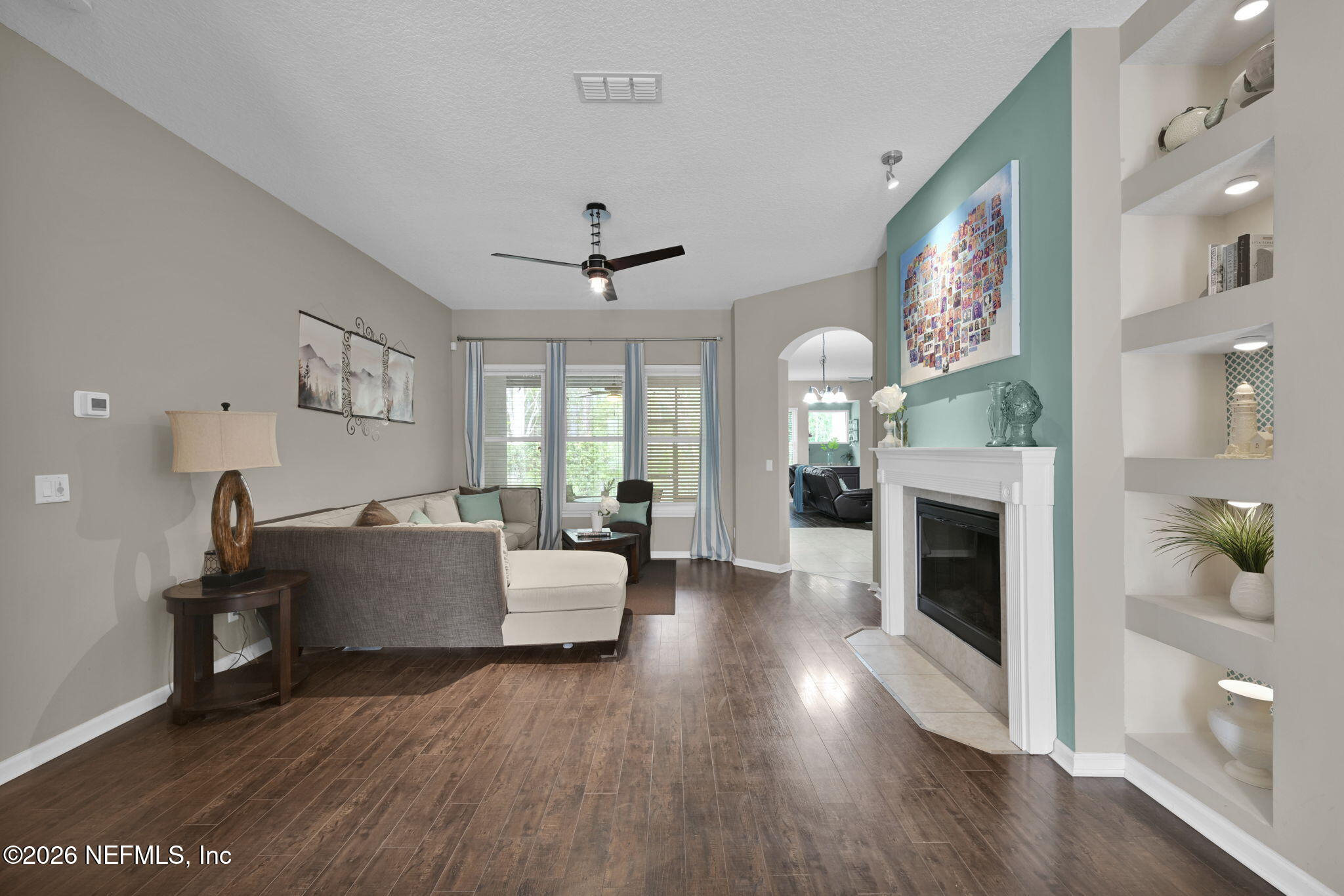 6191 White Tip Road Jacksonville, FL 32258 - Photo 11 of 58 a living room with fireplace furniture and a wooden floor