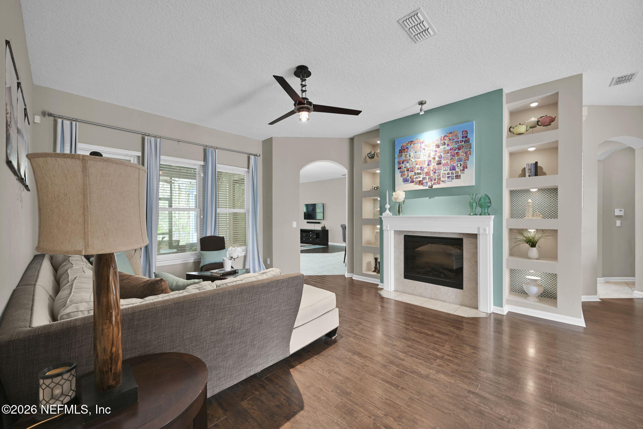 6191 White Tip Road Jacksonville, FL 32258 - Photo 13 of 58 a living room with furniture a fireplace and a flat screen tv