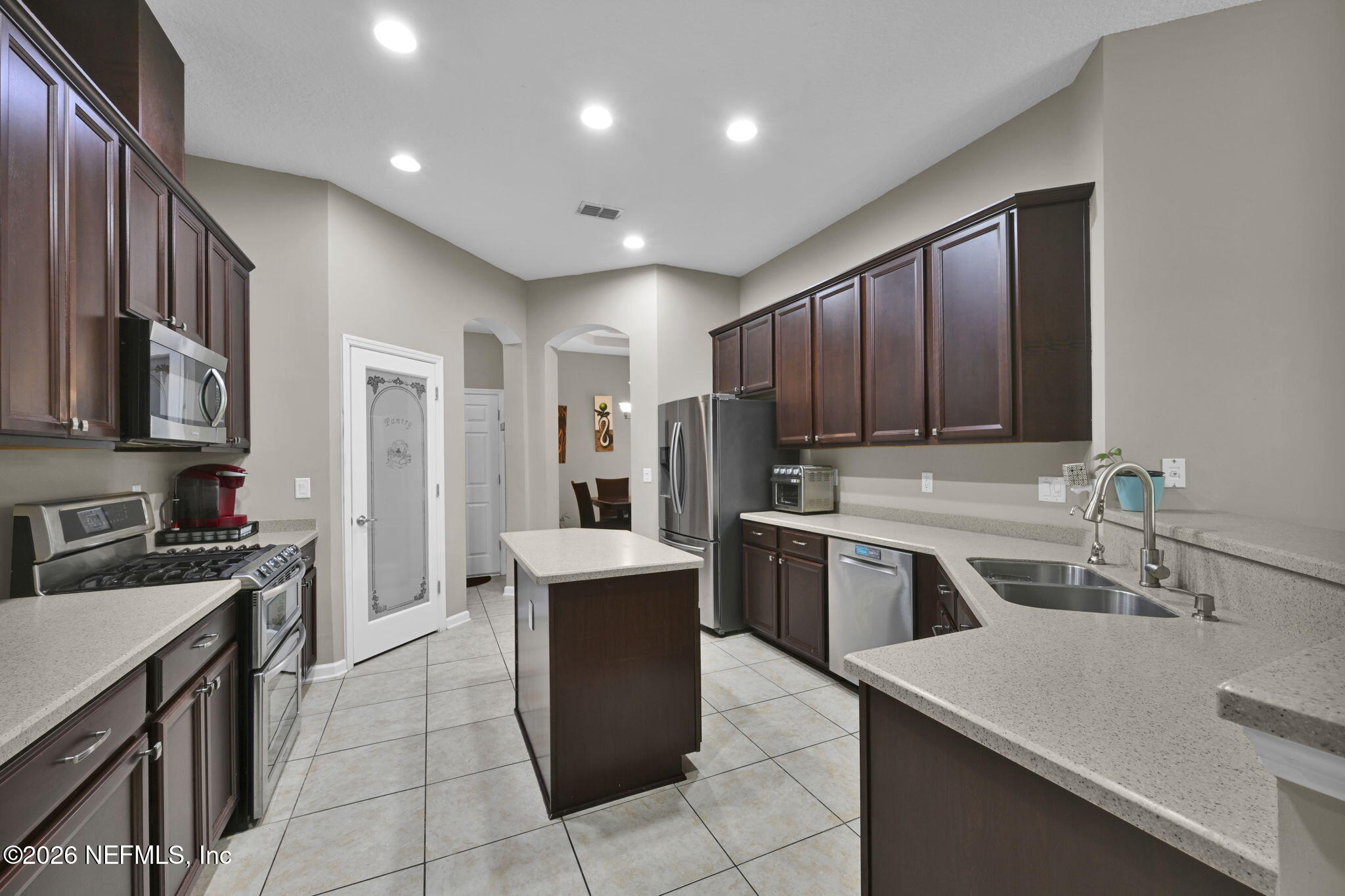 6191 White Tip Road Jacksonville, FL 32258 - Photo 19 of 58 a kitchen with a sink stove and refrigerator