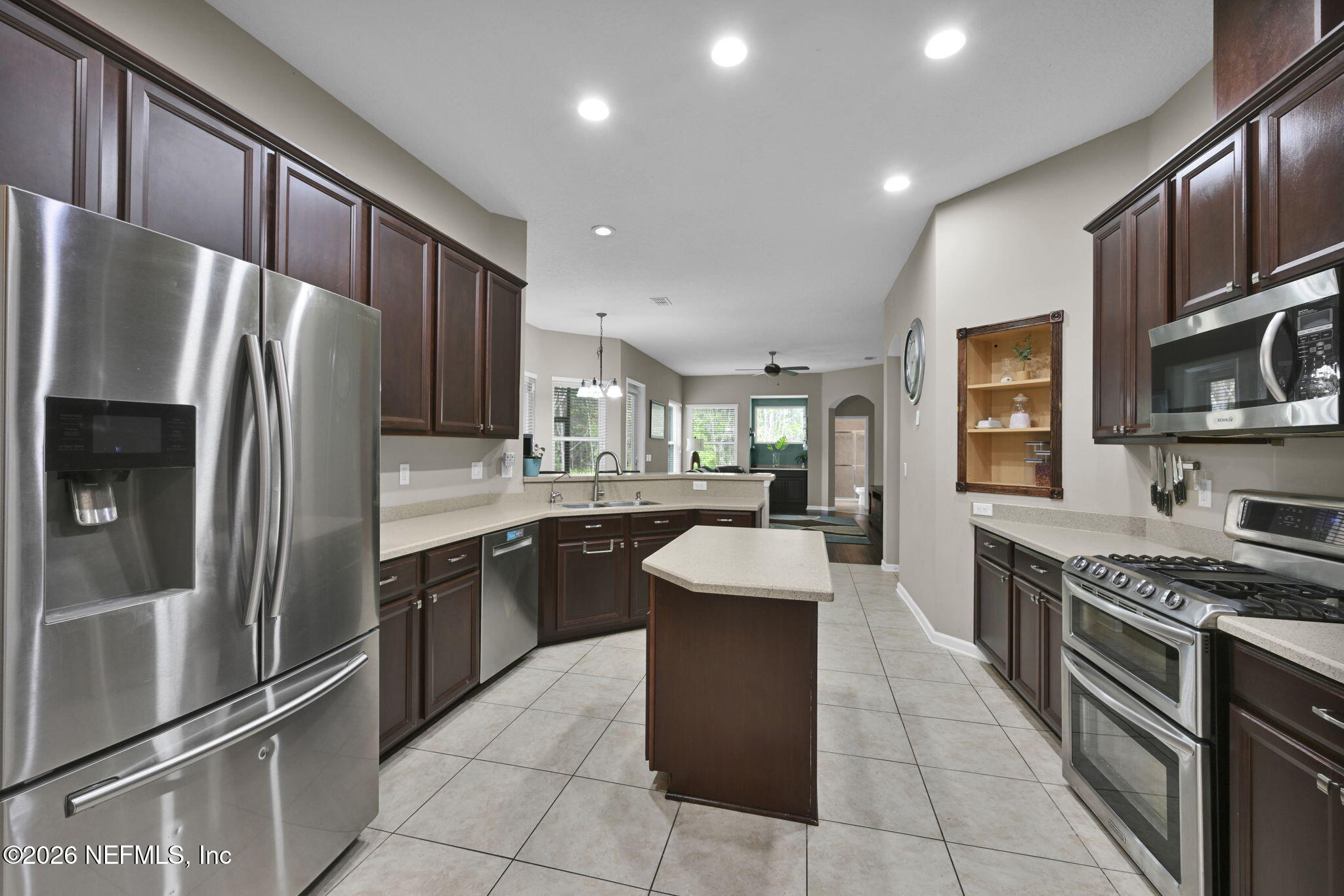 6191 White Tip Road Jacksonville, FL 32258 - Photo 20 of 58 a kitchen with stainless steel appliances granite countertop a refrigerator a sink a stove top oven and a refrigerator