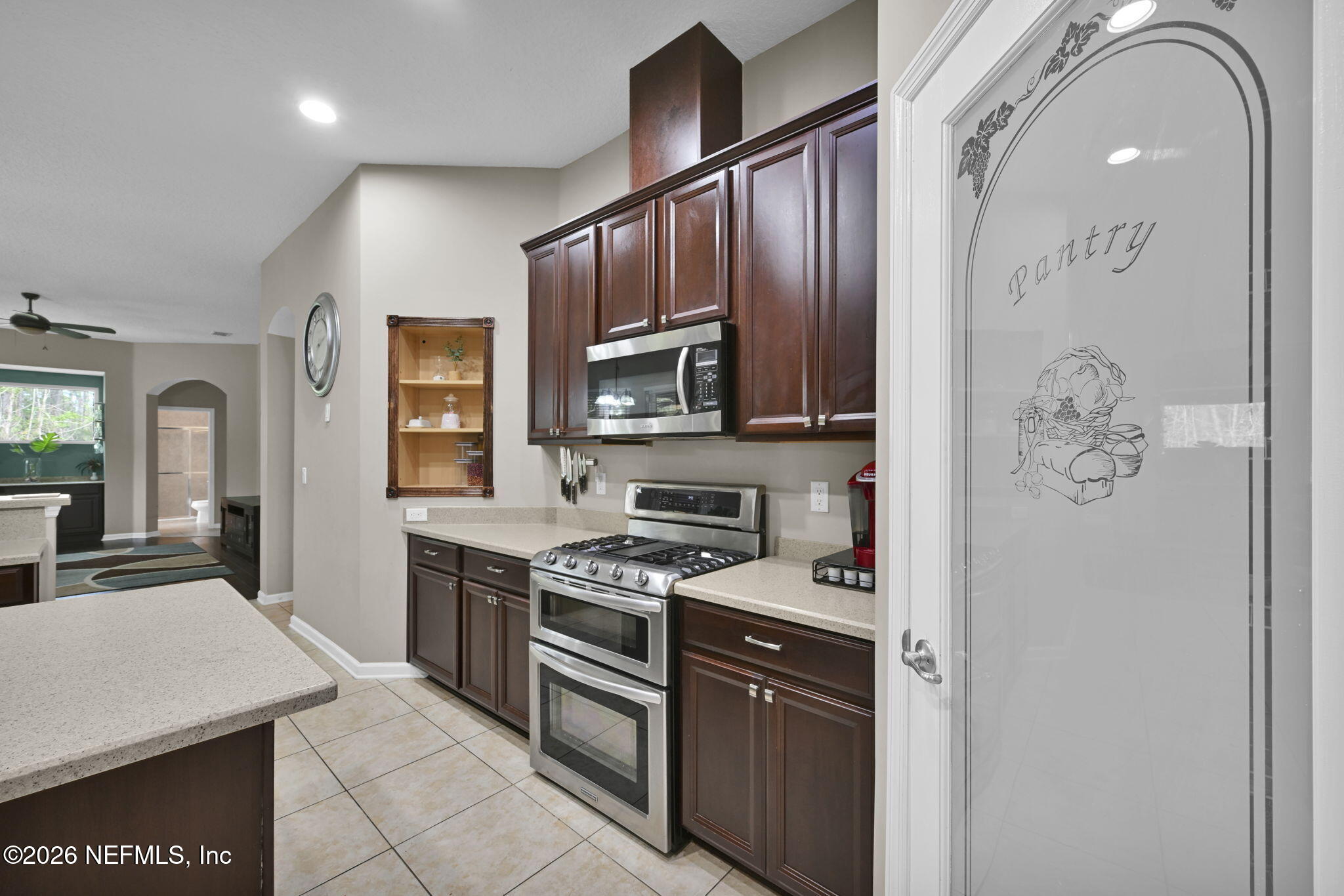 6191 White Tip Road Jacksonville, FL 32258 - Photo 22 of 58 a kitchen with stainless steel appliances granite countertop a stove a sink and a microwave