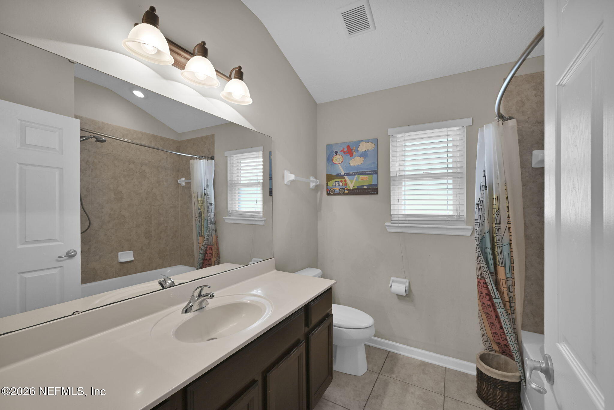 6191 White Tip Road Jacksonville, FL 32258 - Photo 29 of 58 a bathroom with a double vanity sink a toilet and a mirror