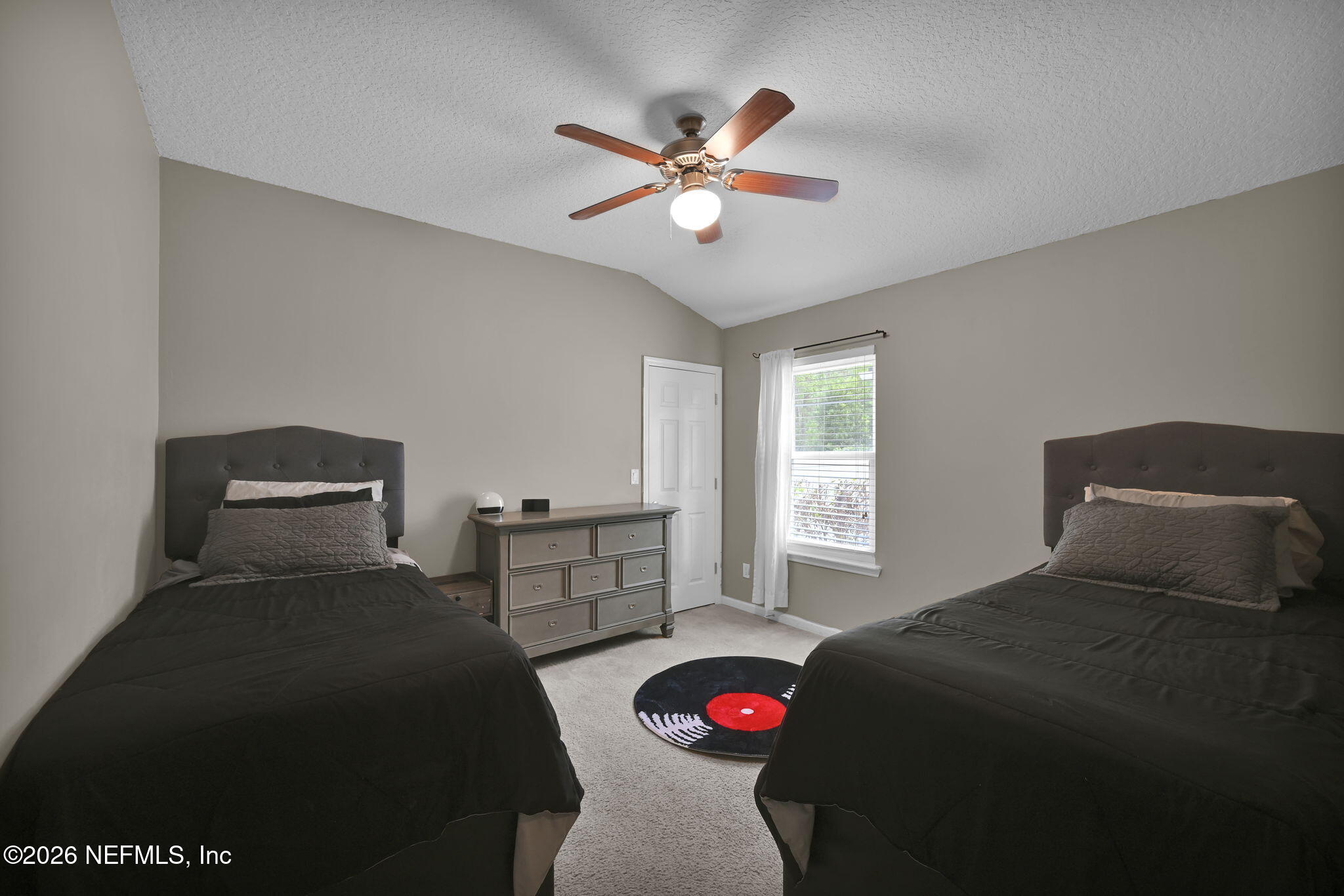 6191 White Tip Road Jacksonville, FL 32258 - Photo 31 of 58 a bedroom with a bed and a chandelier