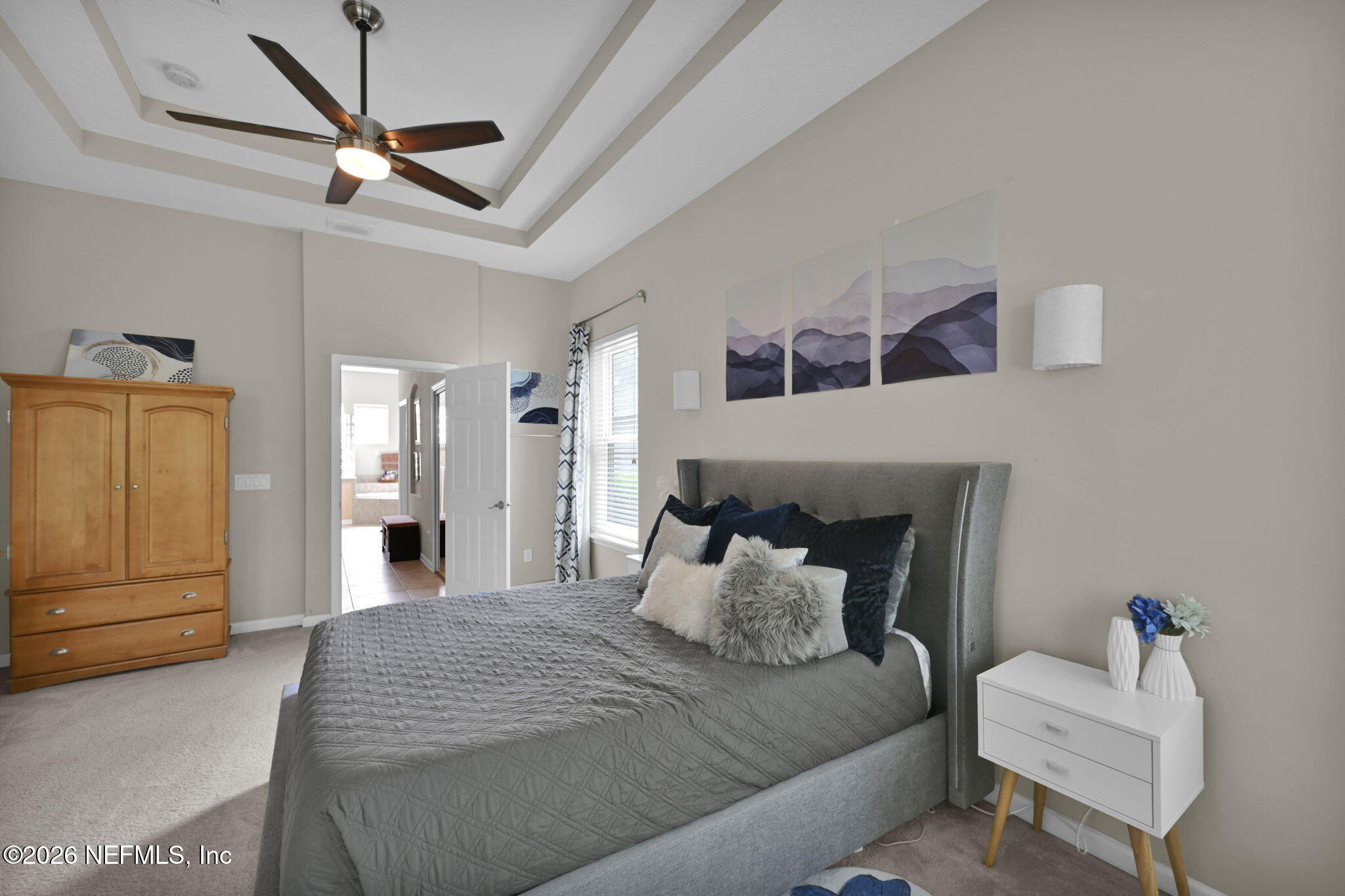 6191 White Tip Road Jacksonville, FL 32258 - Photo 34 of 58 a bedroom with a bed and a chandelier