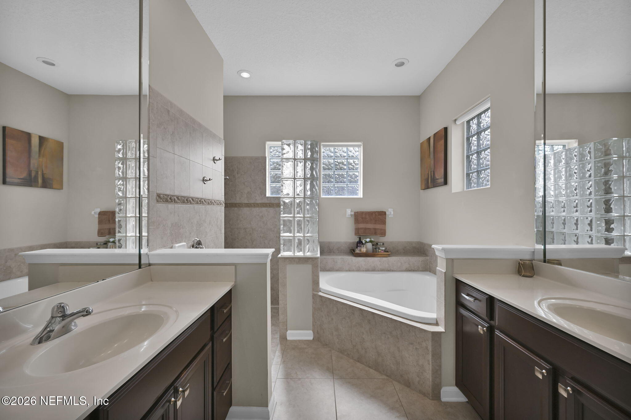 6191 White Tip Road Jacksonville, FL 32258 - Photo 35 of 58 a bathroom with a tub a sink double vanity and a mirror