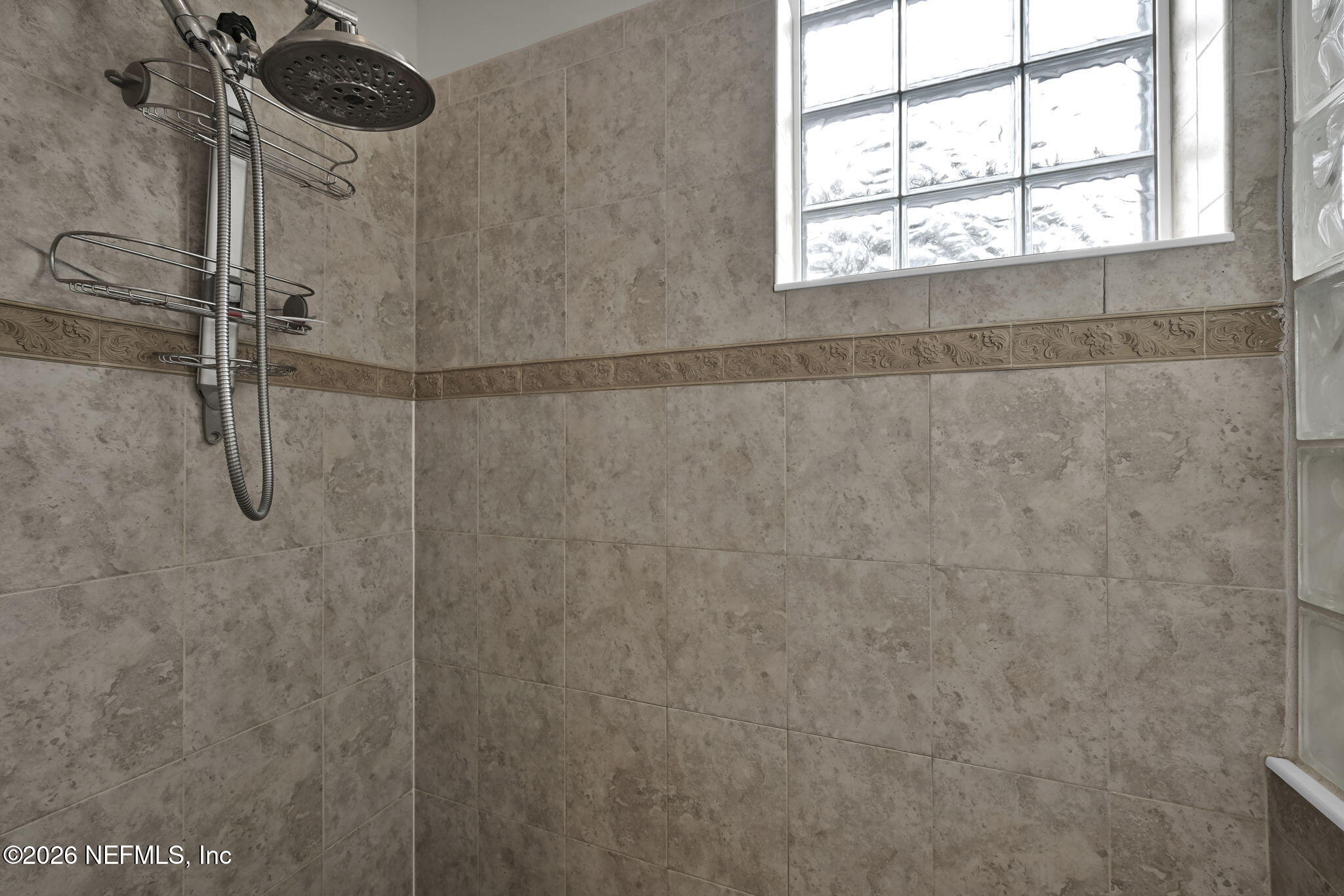 6191 White Tip Road Jacksonville, FL 32258 - Photo 38 of 58 a bathroom with a window and a shower