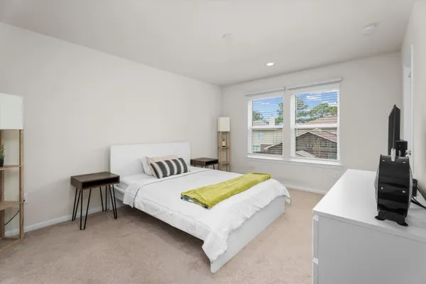 a bedroom with a bed and a table with chair