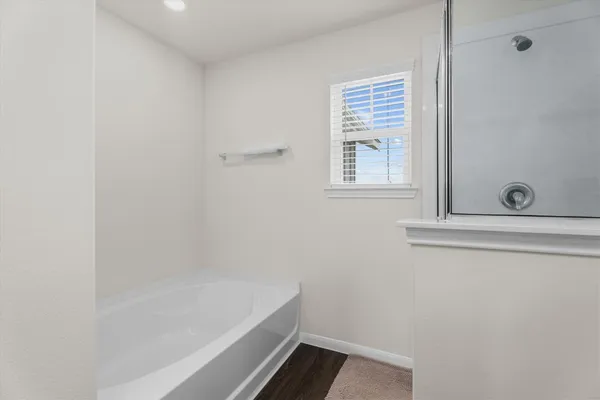 a bathroom with a bathtub and a shower