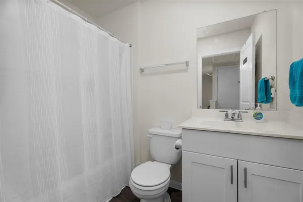 a bathroom with a sink toilet and mirror