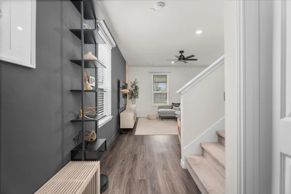 a view of entryway and hall with wooden floor