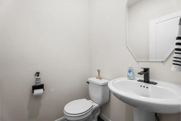 a white toilet sitting next to a bathroom sink