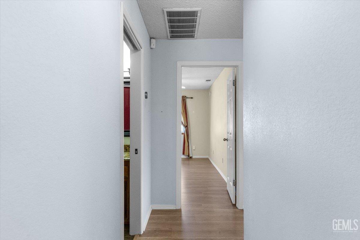 Undisclosed Address Tehachapi, CA 93561 - Photo 14 of 46 a view of a hallway with wooden floor