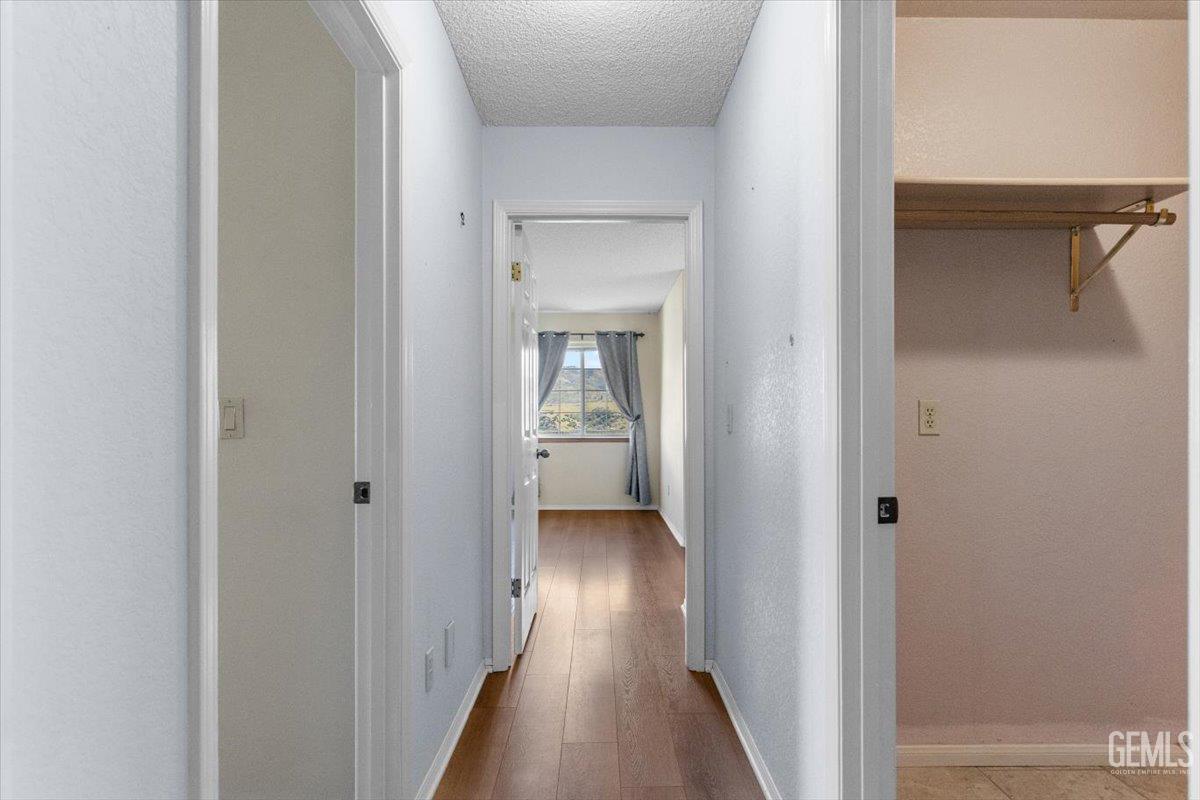 Undisclosed Address Tehachapi, CA 93561 - Photo 20 of 46 a view of a hallway with wooden floor and a bathroom
