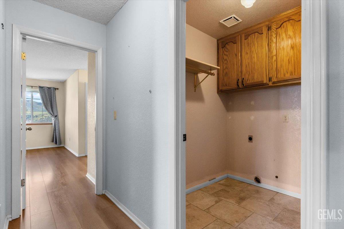Undisclosed Address Tehachapi, CA 93561 - Photo 21 of 46 a view of a hallway with wooden floor and closet