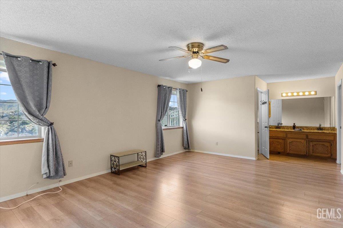 Undisclosed Address Tehachapi, CA 93561 - Photo 26 of 46 a view of an empty room with a window and wooden floor