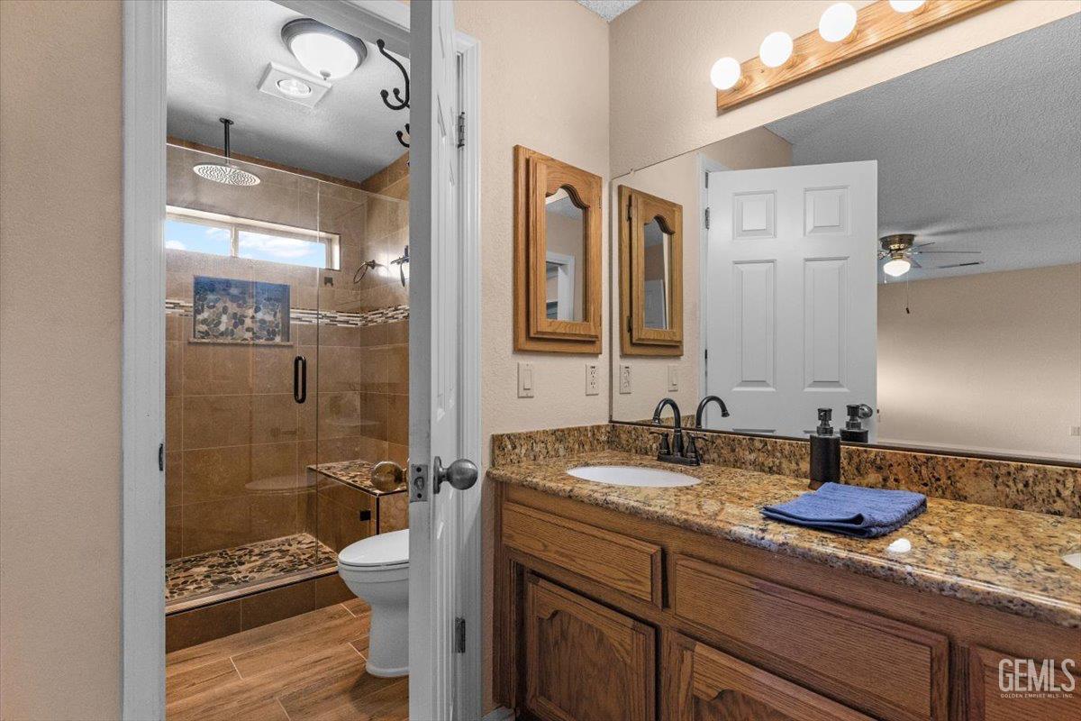 Undisclosed Address Tehachapi, CA 93561 - Photo 28 of 46 a bathroom with a granite countertop sink a mirror and shower