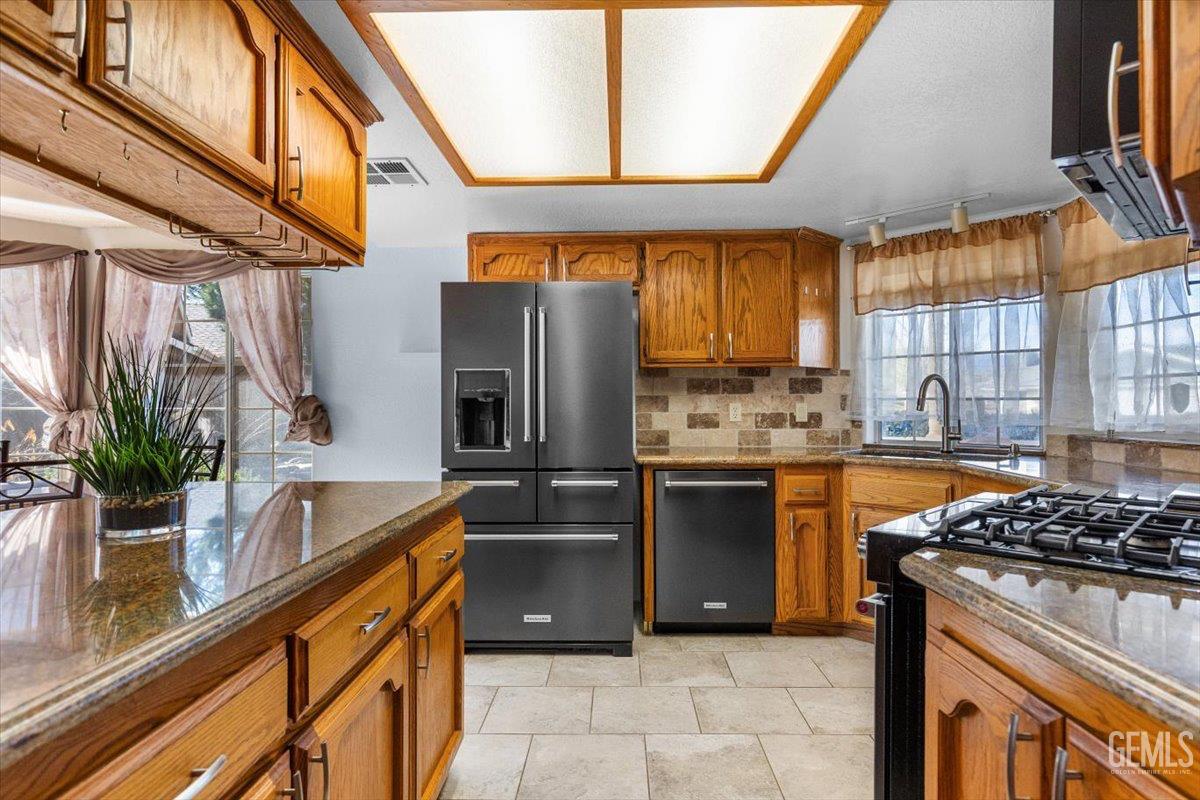 Undisclosed Address Tehachapi, CA 93561 - Photo 6 of 46 a kitchen with stainless steel appliances granite countertop a sink a stove and a refrigerator