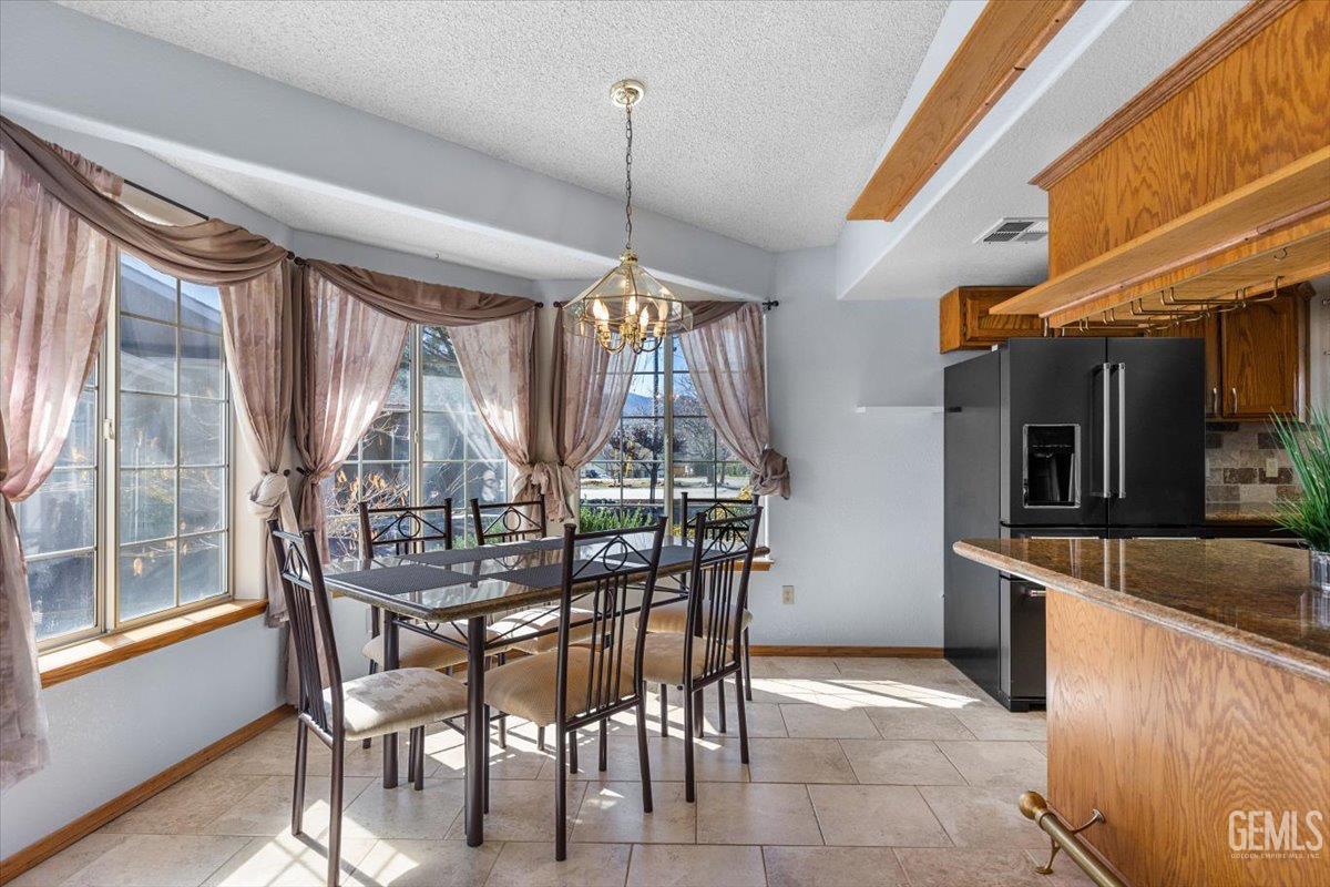 Undisclosed Address Tehachapi, CA 93561 - Photo 8 of 46 a view of a dining room with furniture large windows and wooden floor