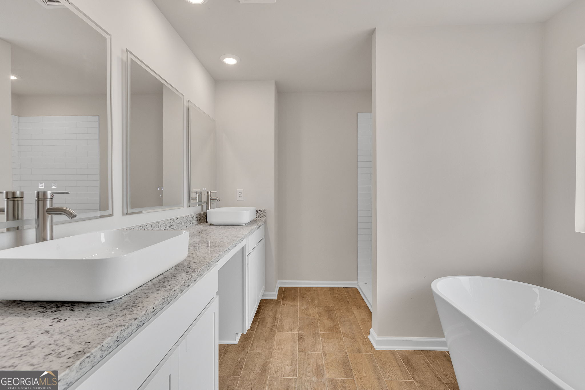 117 Shenandoah Lane, Unit 22D LaGrange, GA 30241 - Photo 11 of 20 a spacious bathroom with a granite countertop sink and a large mirror