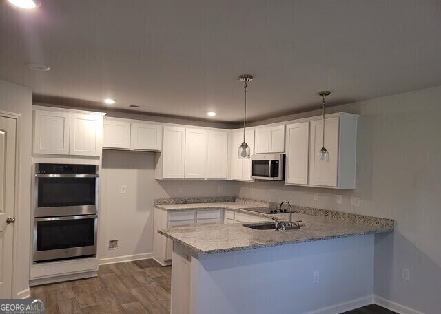117 Shenandoah Lane, Unit 22D LaGrange, GA 30241 - Photo 5 of 20 a kitchen with stainless steel appliances granite countertop a sink stove and refrigerator