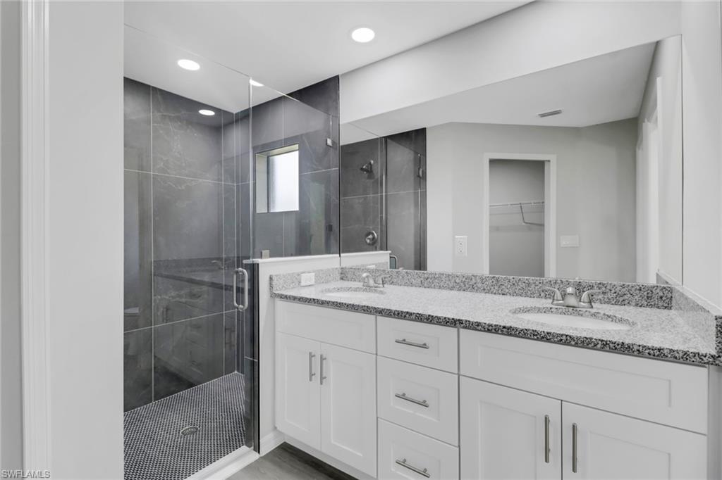 1012 Anza Avenue Lehigh Acres, FL 33971 - Photo 15 of 25 a bathroom with a granite countertop sink mirror and double