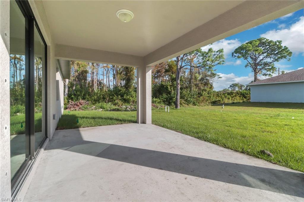 1012 Anza Avenue Lehigh Acres, FL 33971 - Photo 19 of 25 a view of a porch with a yard