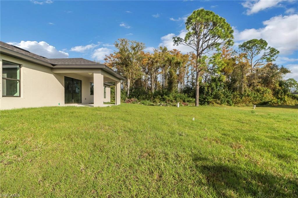 1012 Anza Avenue Lehigh Acres, FL 33971 - Photo 20 of 25 a view of a house with a backyard