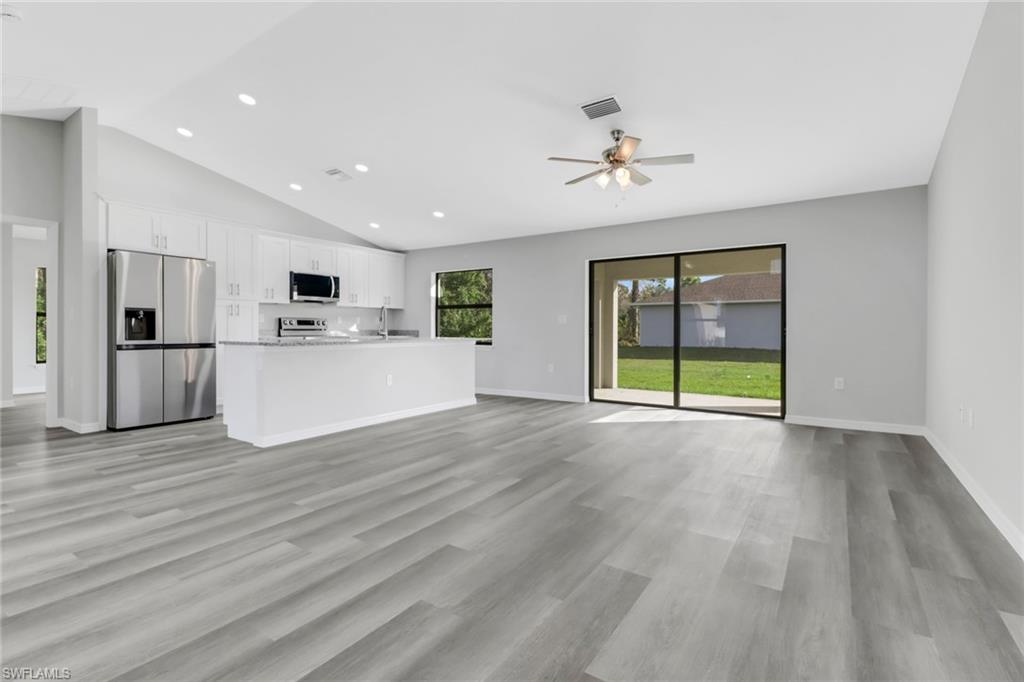 1012 Anza Avenue Lehigh Acres, FL 33971 - Photo 7 of 25 a view of a kitchen with wooden floor and a kitchen