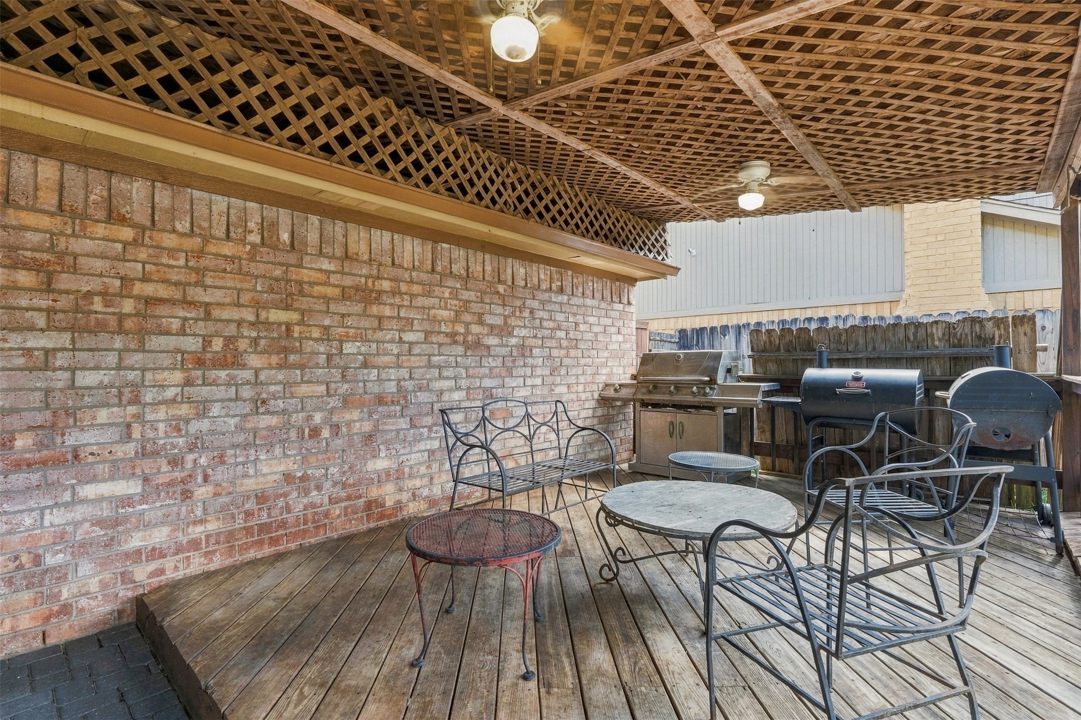 25539 Chapel Ridge Lane Spring, TX 77373 - Photo 23 of 40 Covered patio with a spacious wooden deck, perfect for year-round barbecues, outdoor dining, and entertaining.