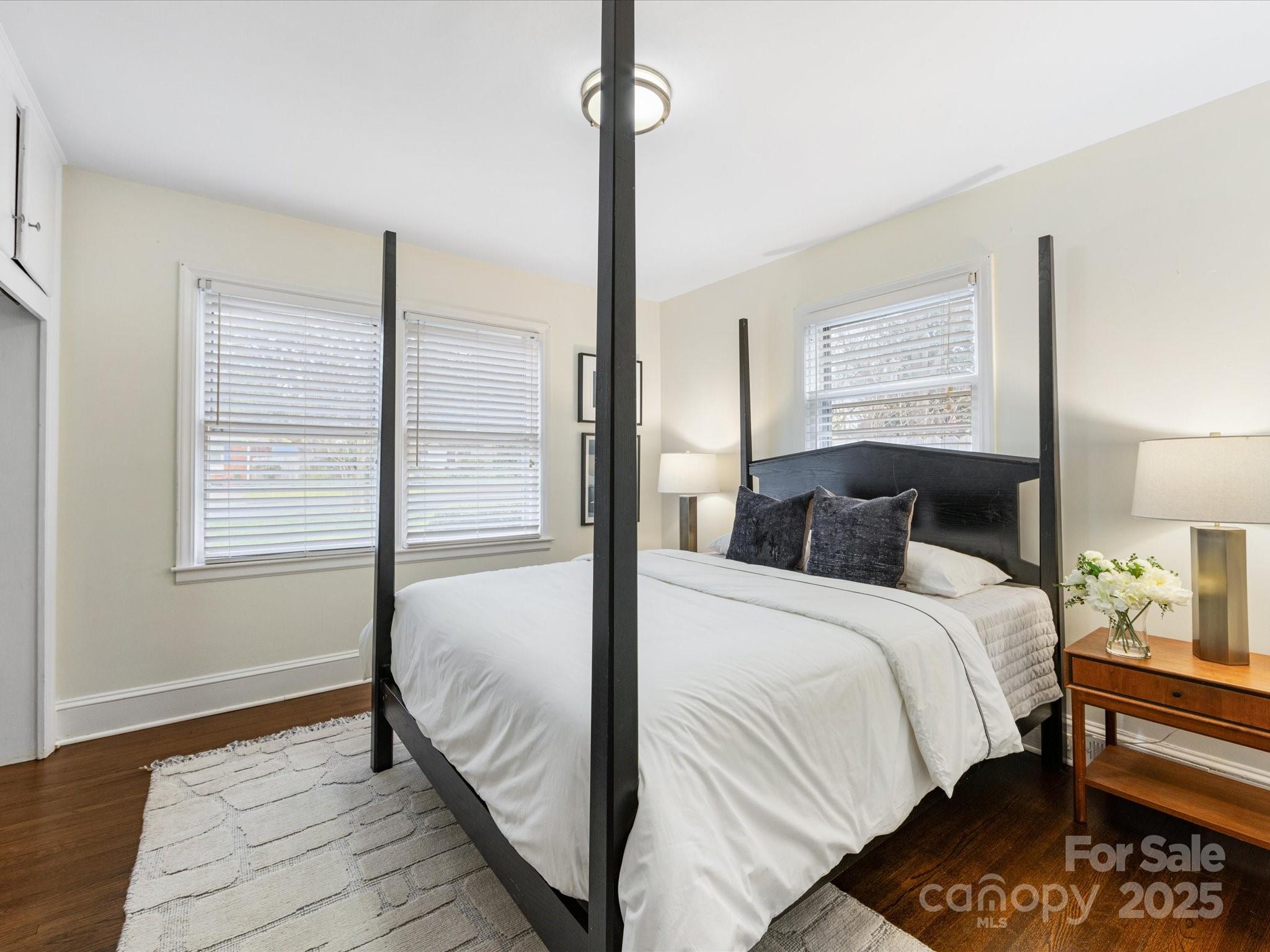 2908 Enfield Road Charlotte, NC 28205 - Photo 19 of 32 a bedroom with a bed and wooden floor