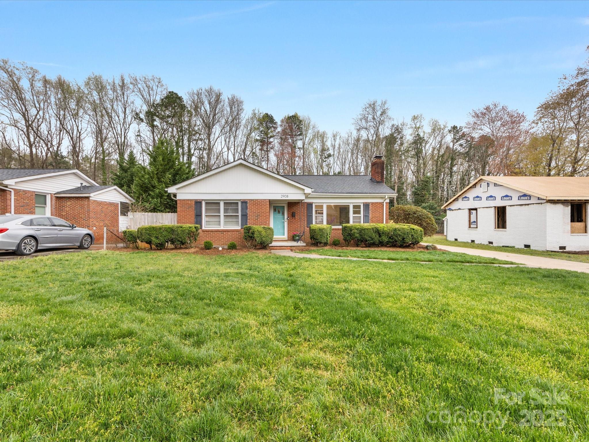 2908 Enfield Road Charlotte, NC 28205 - Photo 2 of 32 a front view of a house with a yard table and chairs