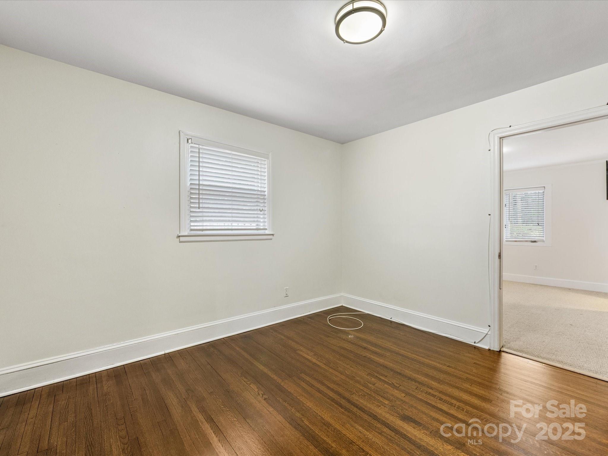 2908 Enfield Road Charlotte, NC 28205 - Photo 22 of 32 an empty room with wooden floor and windows