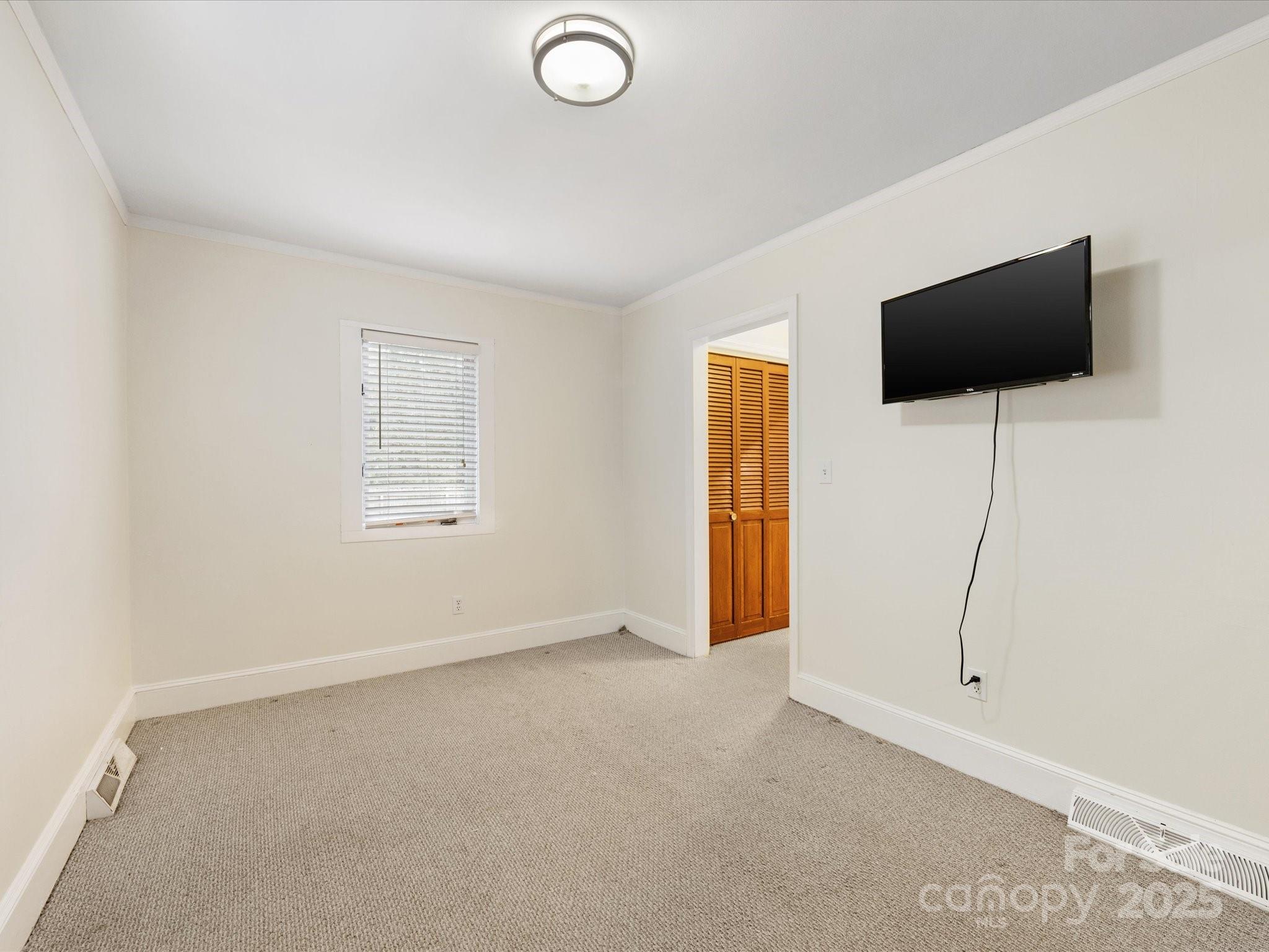 2908 Enfield Road Charlotte, NC 28205 - Photo 27 of 32 a view of a livingroom with an empty space and a window