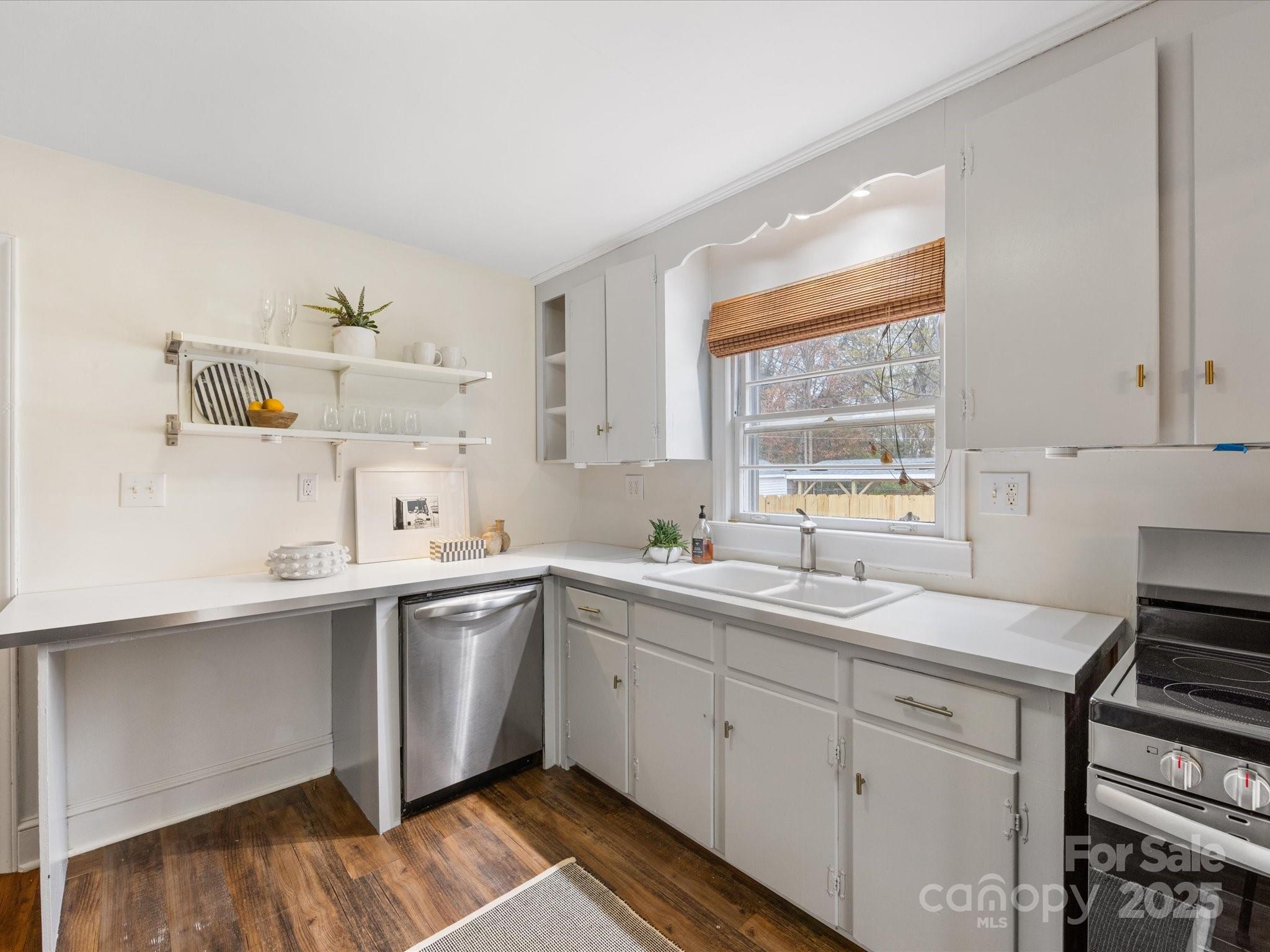 2908 Enfield Road Charlotte, NC 28205 - Photo 8 of 32 a kitchen with a sink cabinets window and stainless steel appliances