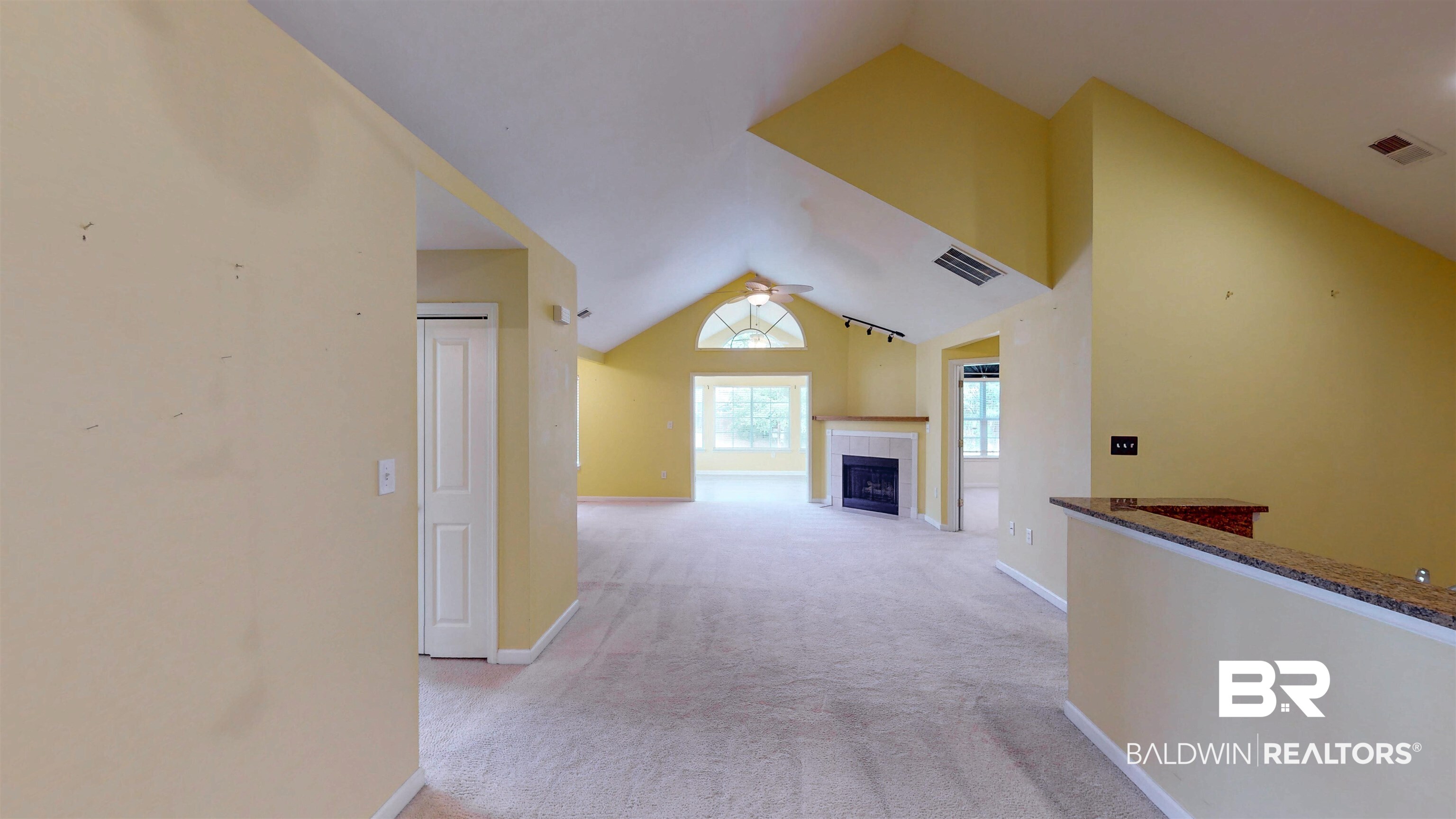 303 Wyld Palms Drive, Unit 303 Foley, AL 36535 - Photo 22 of 36 Hall featuring lofted ceiling and light carpet