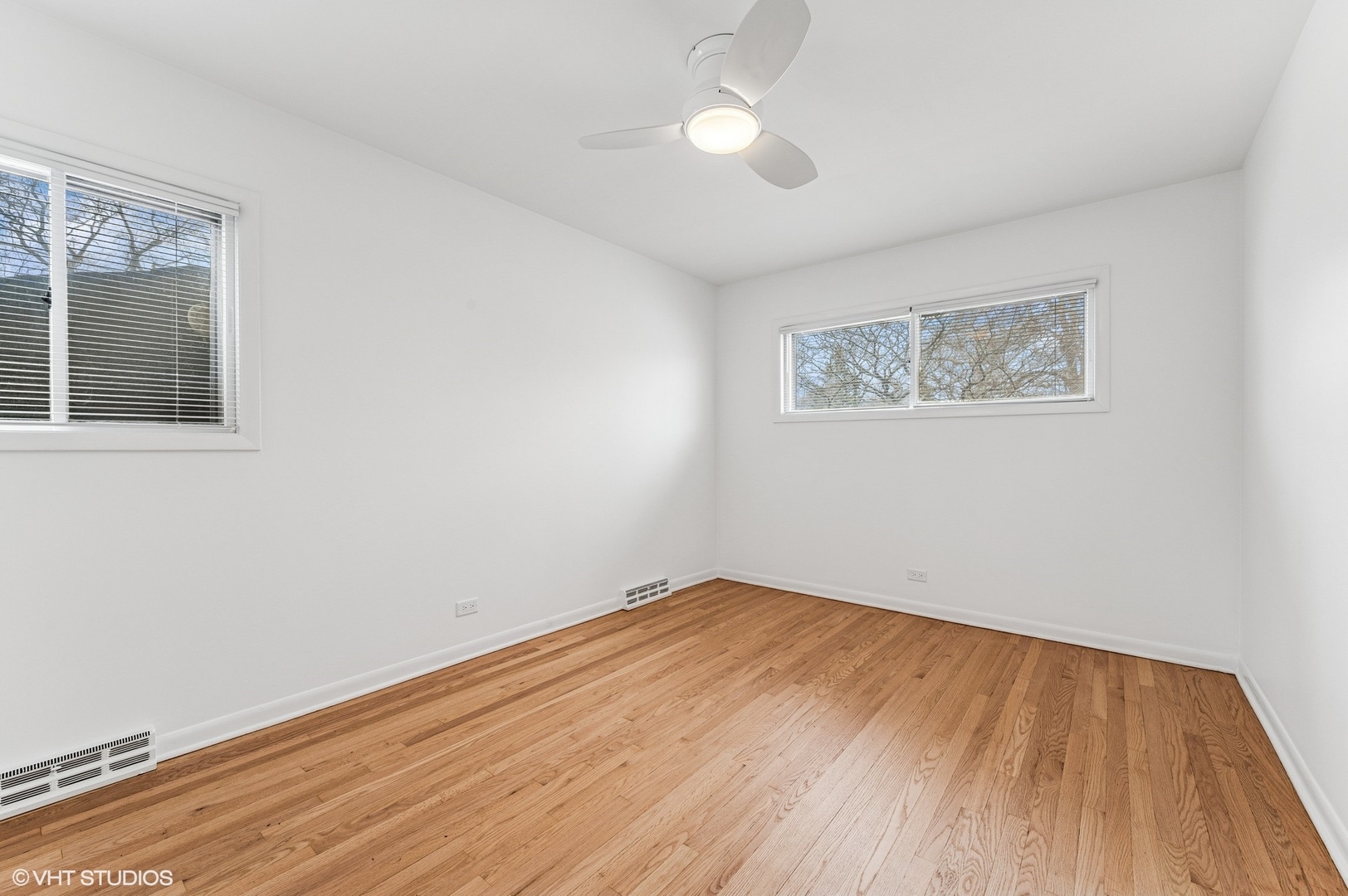 739 Echo Lane Glenview, IL 60025 - Photo 17 of 27 a view of an empty room with wooden floor and a window