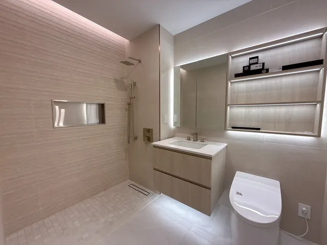 a bathroom with a sink a toilet and mirror