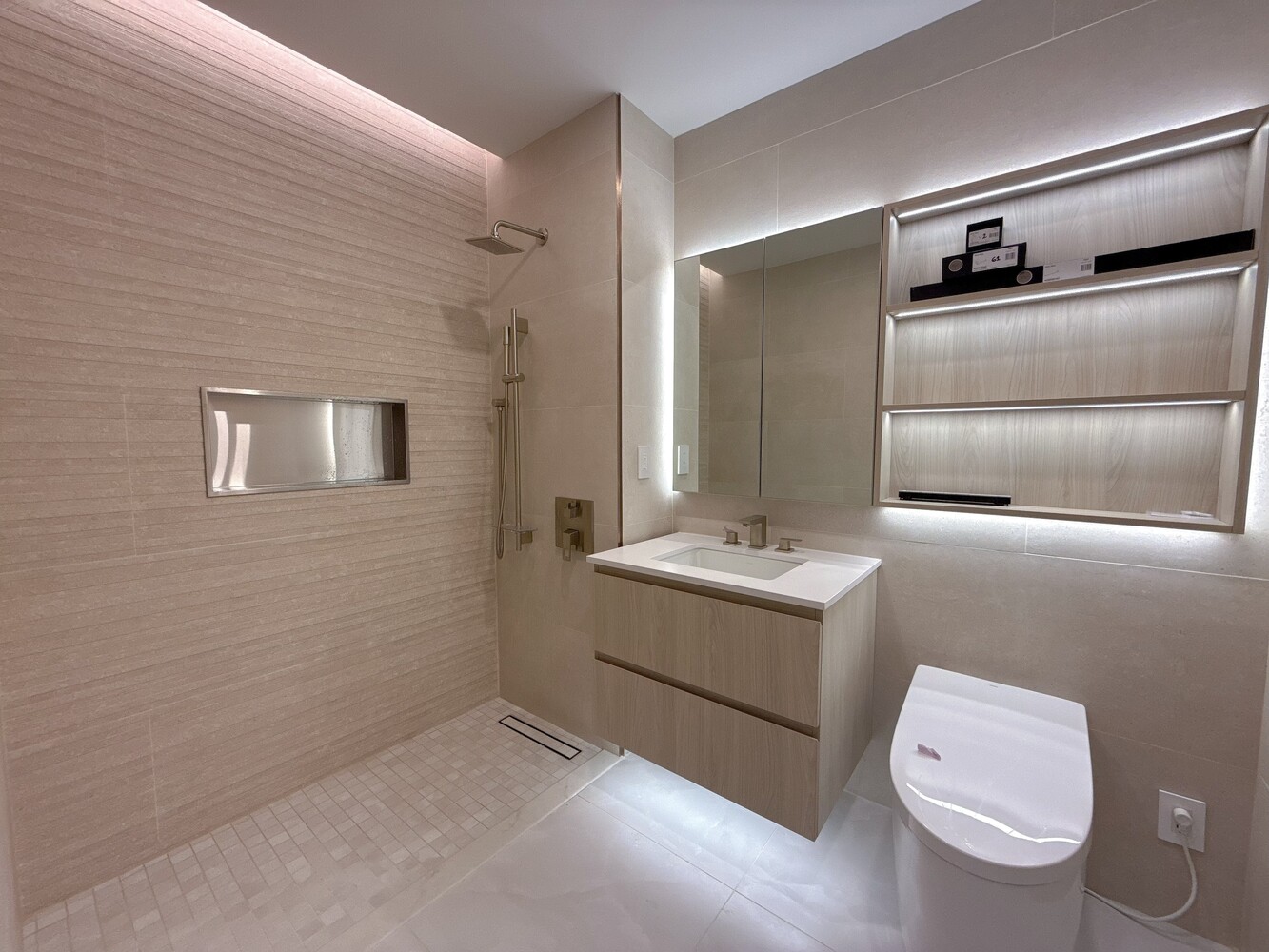 11-36 45th Road, Unit 403A Queens, NY 11101 - Photo 8 of 15 a bathroom with a sink a toilet and mirror