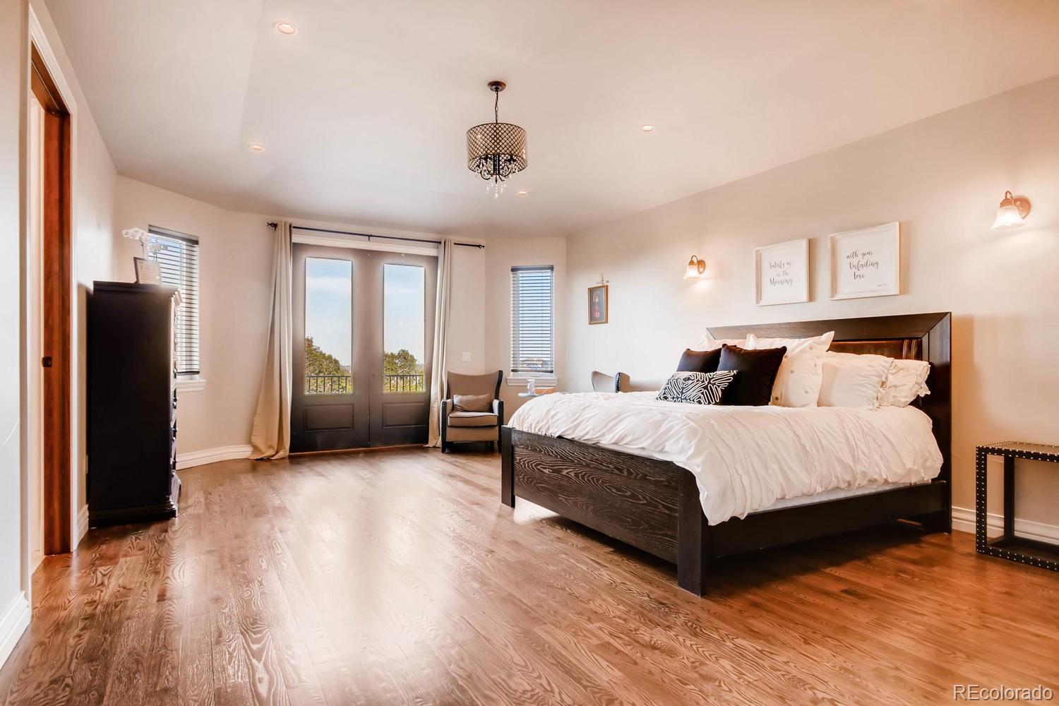4880 Easley Road Golden, CO 80403 - Photo 13 of 40 a spacious bedroom with a bed and a refrigerator