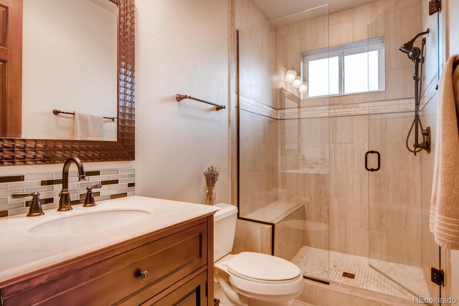 4880 Easley Road Golden, CO 80403 - Photo 18 of 40 a bathroom with a sink a toilet and shower