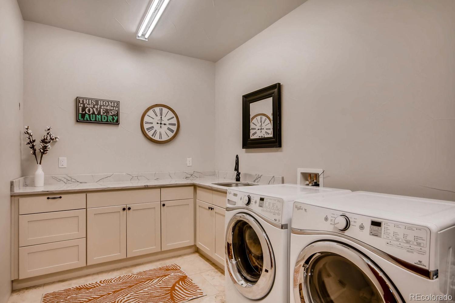 4880 Easley Road Golden, CO 80403 - Photo 19 of 40 a view of storage and utility room with washer and dryer